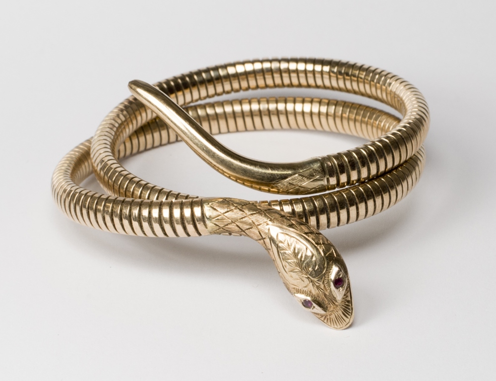 An 18ct. gold mesh bracelet in the form of a snake with ruby set eyes