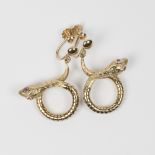 A pair of 9ct. gold drop earrings in the form of snakes with ruby set eyes