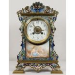 A mantel clock with white enamel dial painted floral swags, striking movement on a gong, in a