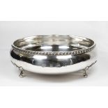 A silver bowl with gadroon border, raised on three leaf clad scroll feet - 8in. dia. Birmingham 1973