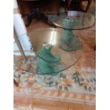 A pair of modern glass occasional tables with spiral twist columns, on circular bases