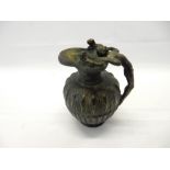 A Grand Tour bronze ewer in the Etruscan style with three lobed rim, the handle in the form of a