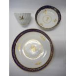 A Worcester Flight and Barr tea bowl and saucer decorated with blue and gilt borders and thistles