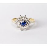 A lady's ring set centre sapphire surrounded by diamonds, on an 18ct. gold shank