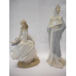 A Lladro model of a lady in blue spotted dress - 10in. high and a Nao figure of a lady with a