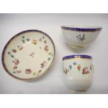 An 18th Century Chelsea Derby cup and saucer decorated with swags of Chinese famille rose style