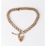 A 9ct. gold hollow link bracelet with heart shaped padlock