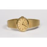 A lady's Tissot wristwatch with oval dial, in an 18ct. gold case, on an 18ct. gold bracelet