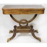 A Regency rosewood card table with 'D' shaped folding top, brass inlaid decoration to the border and