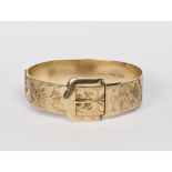 A 9ct. gold bangle of buckle design