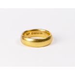 A plain 22ct. gold wedding band