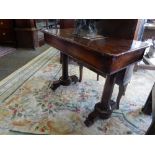 A 19th Century rosewood table with rectangular top, frieze drawer, on tapering panelled ends and