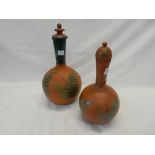 Two Victorian terracotta covered bottle shaped vases decorated in enamel with fern leaves and