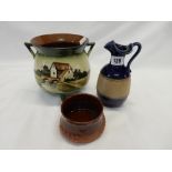 A Devon pottery cauldron decorated with a watermill and river, a Royal Doulton small jug decorated