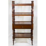 A 19th Century mahogany four tier whatnot, turned supports, fitted centre drawer, on turned legs