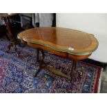A French style kingwood and inlaid table with shaped top, brass border, on lyre form end supports