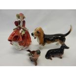 A Beswick model of a Basset hound, a ditto Dachshund, a ditto Chaffinch and a Royal Doulton figure -