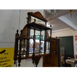 A set of Edwardian mahogany and satinwood inlaid shelves with mirrored backs and turned supports -