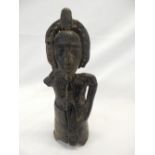 An Eastern carved wood figure - 9 1/2in. high