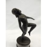 A bronze study of a female nude, on oval base - 12in. high