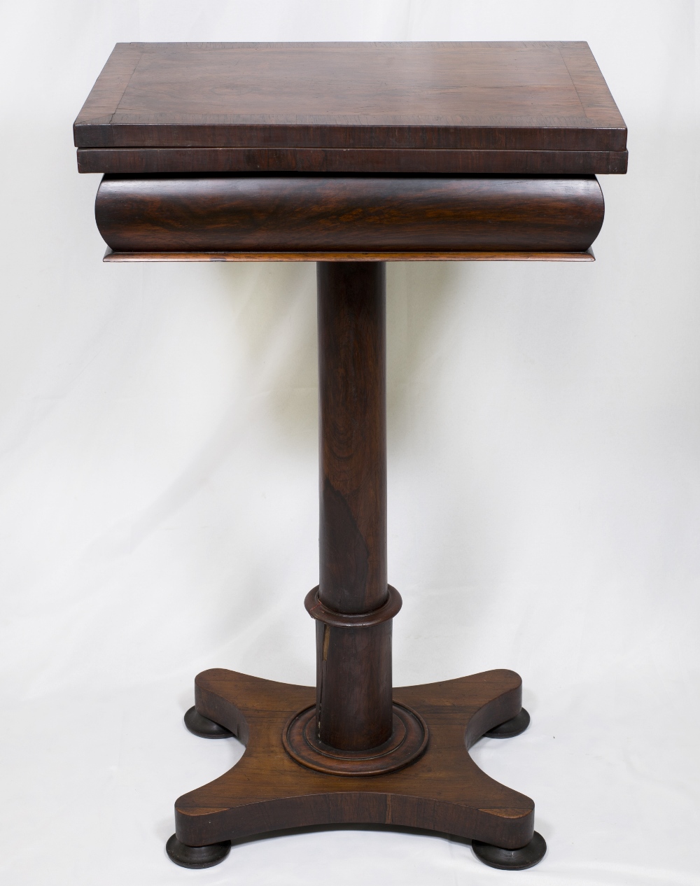 A Victorian rosewood games table with rectangular folding top enclosing chess, backgammon and