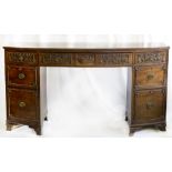 An Edwardian mahogany bow front sideboard, fitted centre drawer with moulded flower, basket and leaf