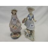 Two Lladro figures of a girl in pink dress with flowers in her skirt and basket - 9 1/2in. high