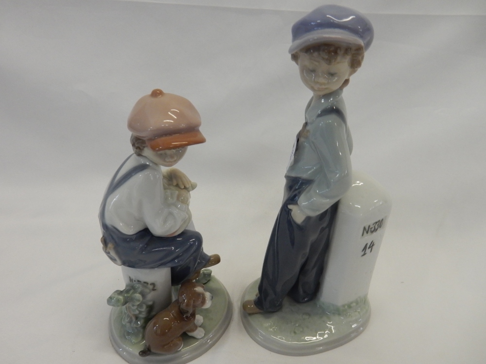 Two Lladro figures depicting a boy standing beside a mile stone - 9in. high and one other of a boy