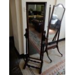 A mahogany framed cheval mirror with turned supports, on downswept legs and twin turned stretchers