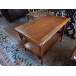 A 20th Century teak two tier occasional table with rectangular top, on tapering