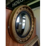 A Regency design convex wall mirror in a gilt ball decorated frame - 24in. dia.