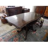 A 19th Century rosewood sofa table fitted two drop flaps with carved edges, two frieze drawers