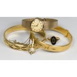 A lady's Tissot wristwatch in a 9ct. gold case, on a 9ct. gold bracelet, two 18kt rolled gold plated