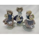 Three Lladro figures of girls each with flower baskets, the largest 7in. high