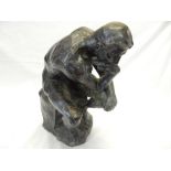 A bronze study of a seated nude on a rocky base - 16in. high