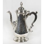 A George III silver coffee pot with armorial crest to the body, acanthus leaf clad spout, on