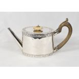 A George III spinsters silver teapot with straight spout, chased decoration - London 1782, makers