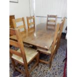 An oak refectory table on carved bulbous legs and a set of six oak framed chairs with ladder backs