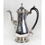 A George III silver coffee pot with engraved coat of arms, acanthus leaf clad spout, half gadroon