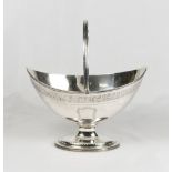 A George III oval silver sugar basket, reeded swing handle, with engraved leaf border, vacant