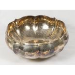 A Continental silver bowl with serpentine edge and hammered decoration, inscribed to the base - 8in.