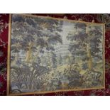 A machine made wall hanging depicting a landscape scene with castle and trees, gold woven border -