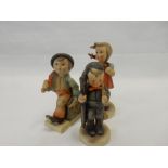 Three Hummel figures - Girl with a basket, chimney sweep, and boy with an umbrella and bag