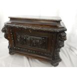 A Victorian oak wine cooler with lion mask carved handles and carved decoration to the front