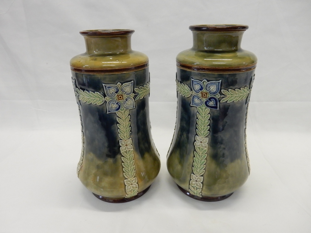 A pair of Royal Doulton vases, mottled blue and green with tube lined decoration of flowers and