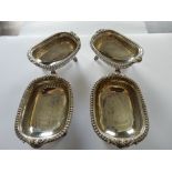 A set of four George III silver salts, rectangular with half fluted decoration, on four paw feet -