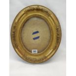 A relique with lace work decoration and Saints names to the border, in an oval gilt frame
