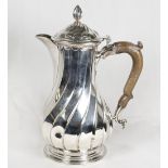 A George II silver hot water jug of wrythen form - London 1757, makers mark for Lewis Herne and