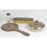 A lady's hand mirror in engine turned silver, a clothes brush with silver back, a glass powder