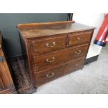 A mahogany finished chest with low raised back, fitted two narrow and two wide drawers - 39in. wide